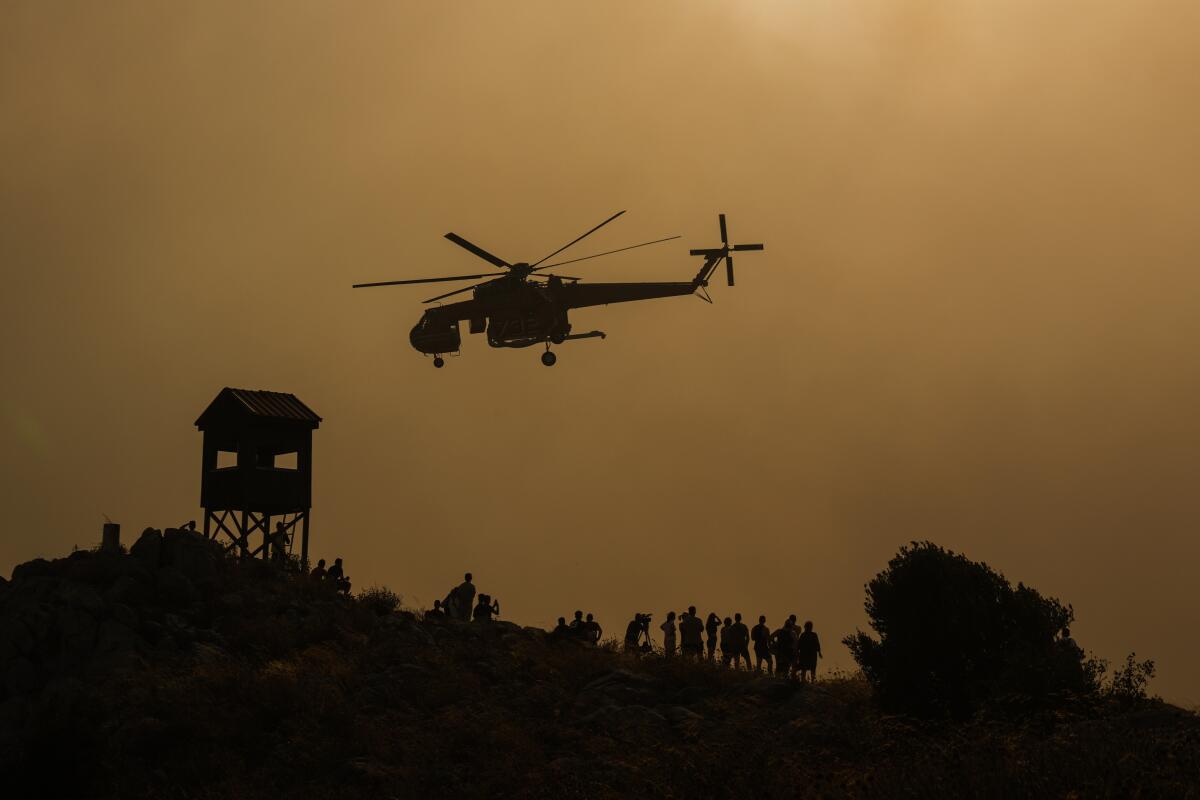 Wildfires in Greece close highways and threaten an oil refinery